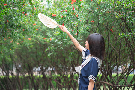 夏天扇子摄影照片_夏季白天美女户外扇子摄影图配图