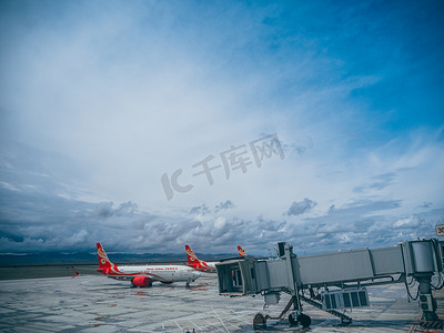 桌面风景图片摄影照片_飞机场白天飞机和登机走廊广场准备起飞摄影图配图