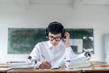 自习教室摄影照片_正在教室听歌自习学习看书的学生