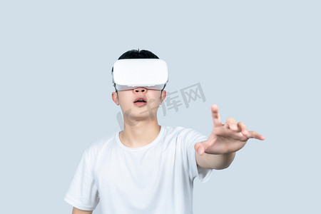 年轻白t男性戴VR眼镜体验虚拟现实游戏场景