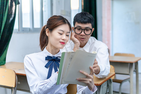 在校园课室里互相学习的青春男女大学生