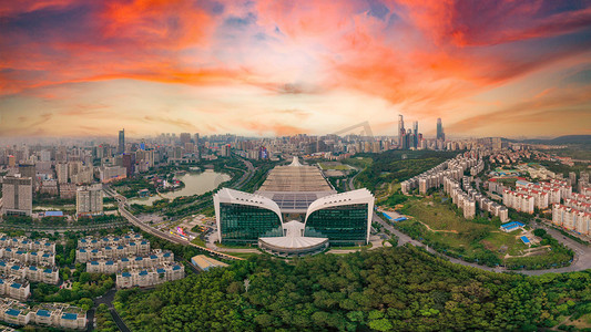 湖畔桃花摄影照片_城市晚霞广西南宁比翼双飞建筑广场无人机摄影图配图