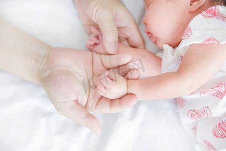 婴儿手势新生婴儿大手拉小手母婴小手摄影图配图