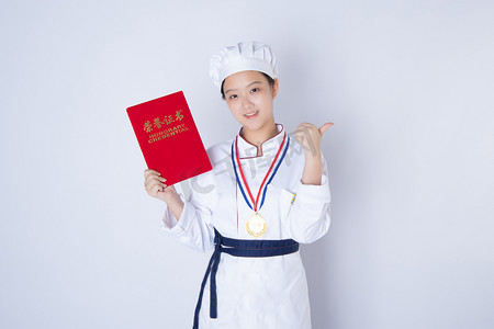 年轻女厨师白天一个女厨师白背景拿着获奖证书摄影图配图