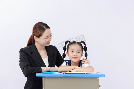 老师讲解摄影照片_教师节早上老师学生教室里书桌摄影图配图