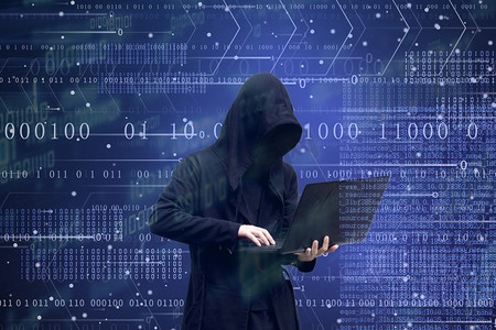 加强安全生产摄影照片_捧着电脑的黑客黑客的形象大数据黑客防御科技安全