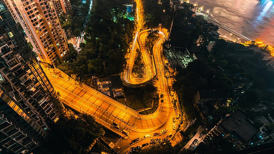 弯曲泼墨摄影照片_重庆城市弯曲道路夜景灯光车流