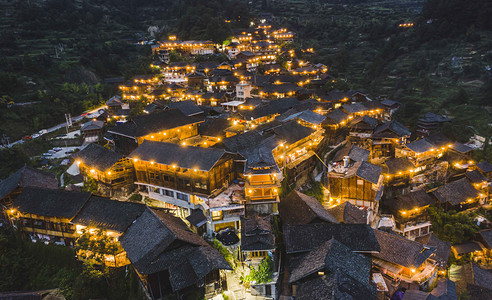 古建彩绘摄影照片_城市夜晚贵州西江千户苗寨夜景航拍景区无人机摄影图配图