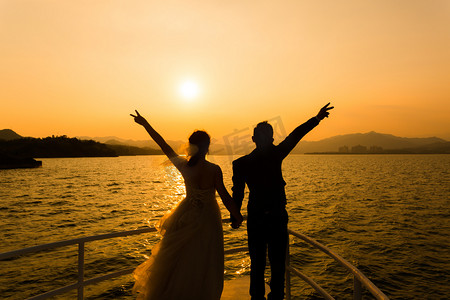 情侣结婚摄影照片_人物剪影照片夕阳户外户外举手摄影图配图