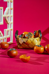 红色背景柿子中午柿子室内静物摄影图配图