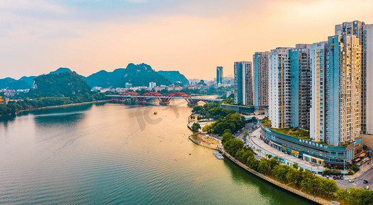 城市河流摄影照片_城市建筑夕阳广西柳州一线江景住宅楼建筑群航拍摄影图配图