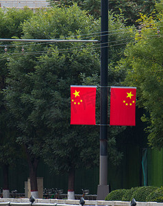 国庆节城市街边红旗特写白天红旗马路边飘扬摄影图配图