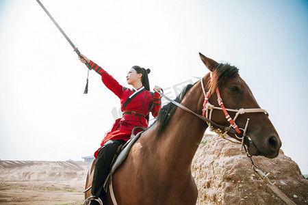 人物指天摄影照片_武侠白天汉服女侠户外用剑指天摄影图配图