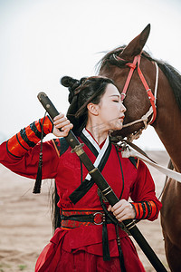 武侠人物古风摄影照片_武侠白天战马和女侠户外拔剑摄影图配图