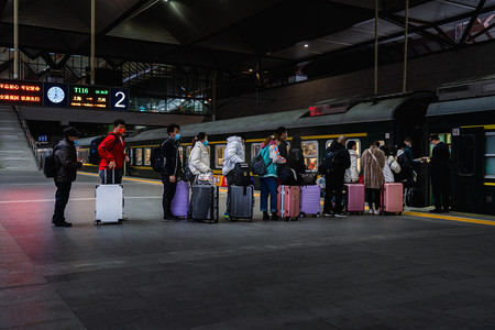 春运返乡摄影照片_火车站旅客进站上车排队检票摄影图配图