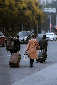 意境人物摄影照片_背着行囊返乡过年的人物背影摄影图配图