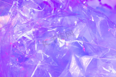 炫彩蓝紫色摄影照片_镭射白天糖果纸室内幻彩摄影图配图