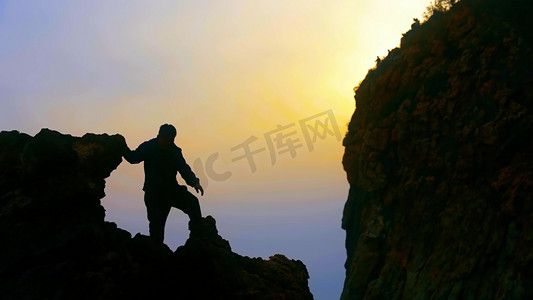 企业山峰摄影照片_男人登山攀登山峰