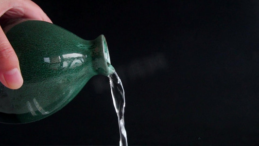 水流抛物线摄影照片_酒瓶倒白酒镜头水流慢镜头