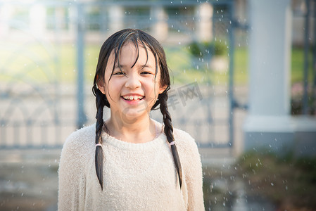 高兴极了摄影照片_亚洲女孩很高兴与雨