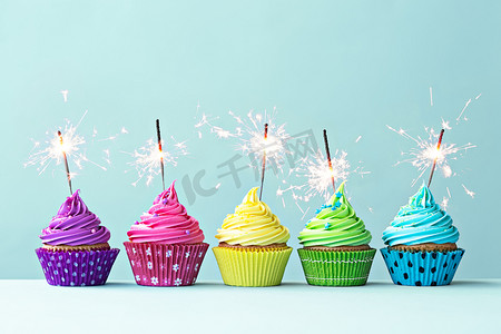 Food摄影照片_Colorful cupcakes with sparklers
