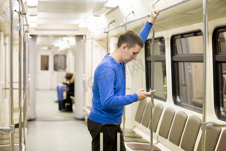 passenger摄影照片_Young passenger in subway train