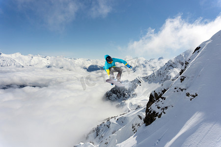 滑雪板骑手跳跃于群山之巅。极端的滑雪随心所欲的运动.