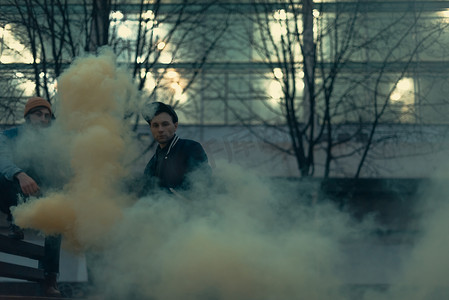 创意坚持摄影照片_城市里有烟雾弹的年轻街头艺人