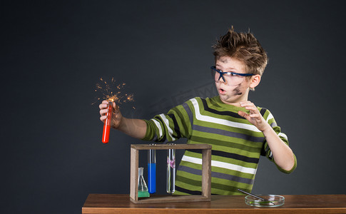 冰爽爆炸摄影照片_小男孩进行实验。疯狂科学家.