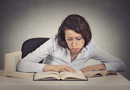 woman student with desperate expression looking at her books