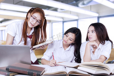 Three lovely female learners studying in class