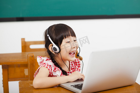 快乐的小女孩，学习在教室中的计算机