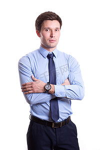 close portrait of a handsome young man in office clothes in a blue shirt trousers tie stands isolated on a white background