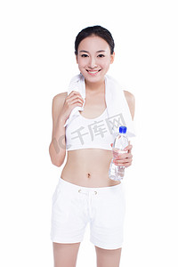 矿泉水瓶摄影照片_健康的亚洲女性，用毛巾和矿泉水瓶