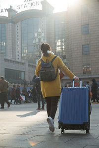 春运摄影照片_青年女人在站前广场