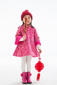 糖葫芦串摄影照片_欢乐的小女孩吃糖葫芦