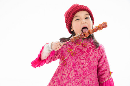 拜年背景摄影照片_欢乐的小女孩吃糖葫芦