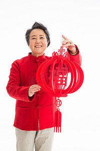 红色元旦中国结摄影照片_老年人庆祝新年
