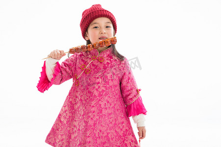 欢乐童年背景摄影照片_欢乐的小女孩吃糖葫芦