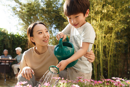 母亲和儿子在花园里浇花