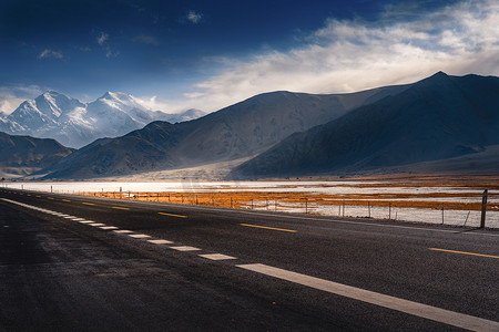 公路摄影照片_新疆喀什帕米尔高原的公路和雪山摄影图配图