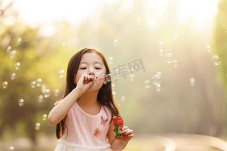 彩色泡泡摄影照片_可爱的女孩在户外