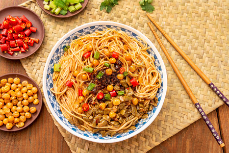 餐饮摄影照片_餐饮美食白天红油拌面木桌摆放摄影图配图