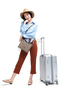 托行李的女人摄影照片_青年女人旅行