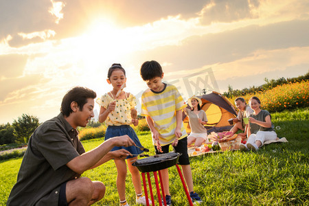 欢乐的一家人在郊外野餐烧烤