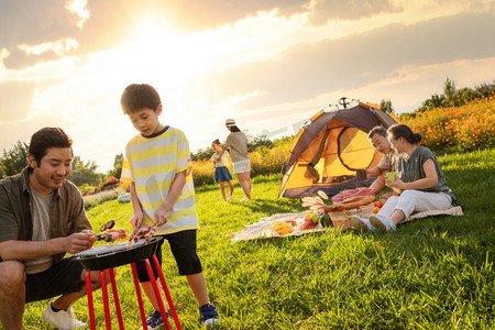 欢乐的一家人在郊外野餐烧烤