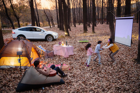 秋天傍晚幸福家庭在户外露营