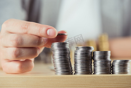 person stacking coins 