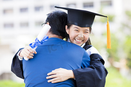 certificate摄影照片_female student and family hug celebrating graduation