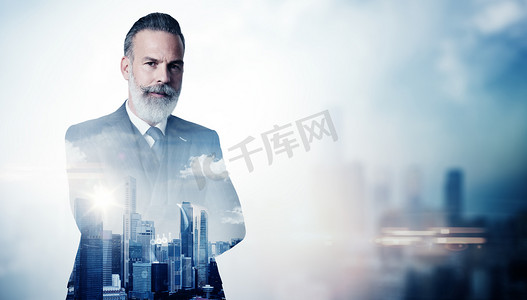 Portrait of bearded businessman in suit and double exposure city on the background. Horizontal